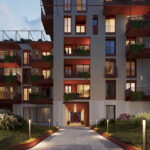 Vista serale di un edificio residenziale del progetto Bologna Bloom, con illuminazione e aree verdi.